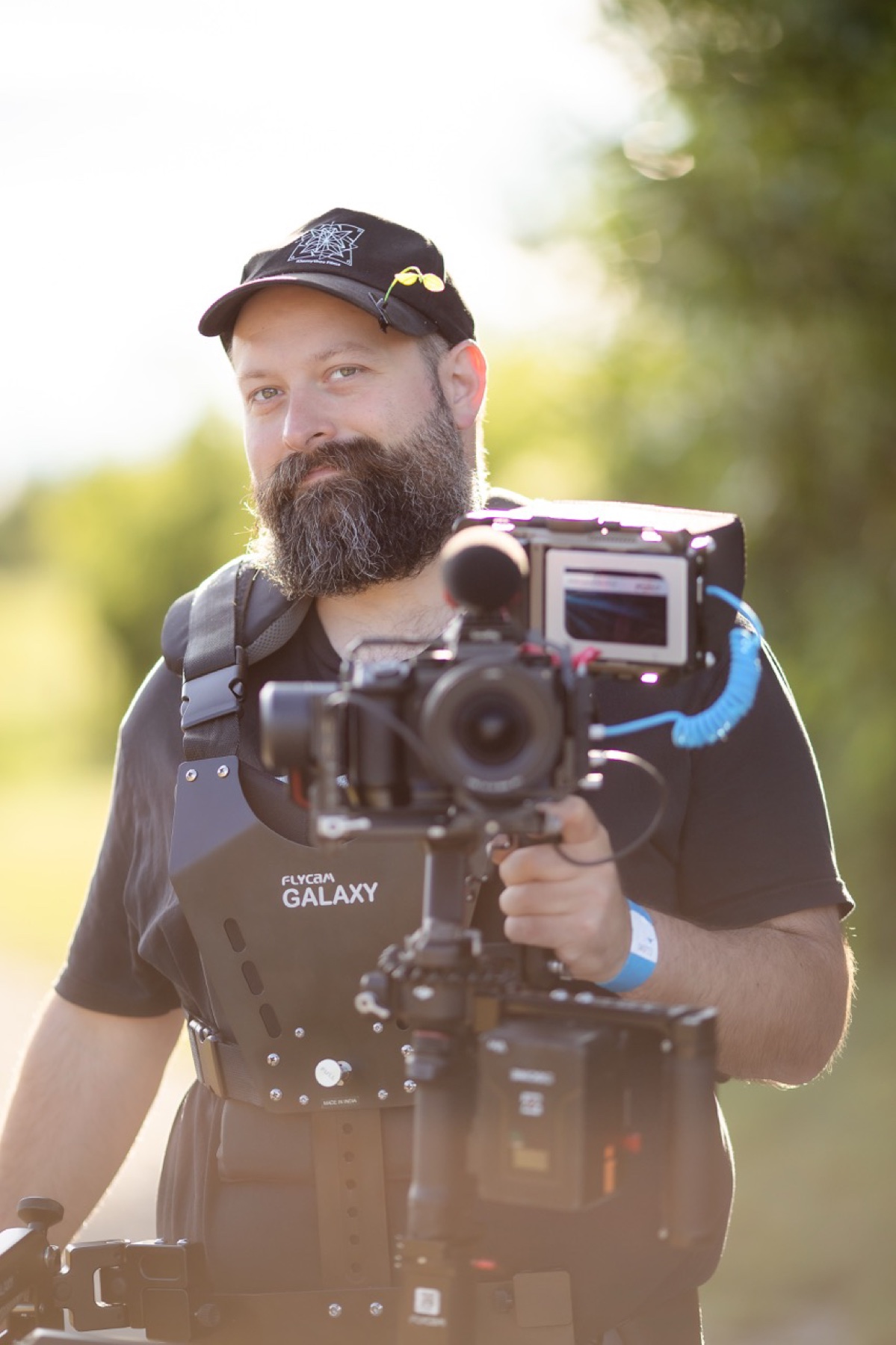 Kia operating a cinema camera rig outdoors at an event.